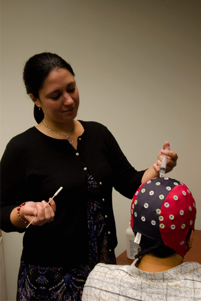 Image of a postdoctoral fellow Amy Starosciak preparing for EEG recordings.