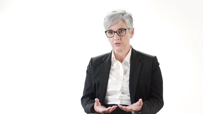 Magda Giordano sitting in front of a white backdrop discussing how to advocate for yourself
