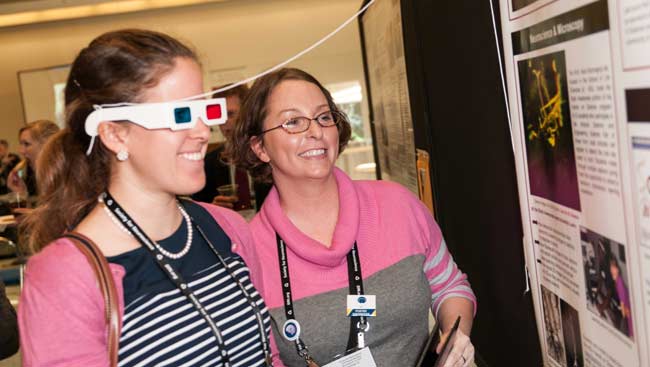 Two women engaged in a Brain Awareness activity.