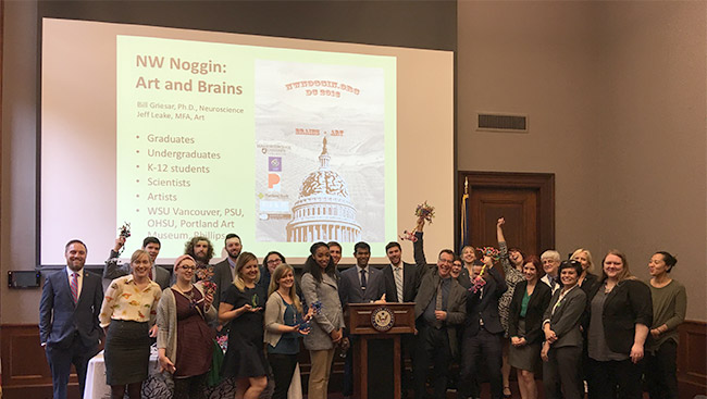 The outreach group, NW Noggin, prepares to present to congress about their research. 