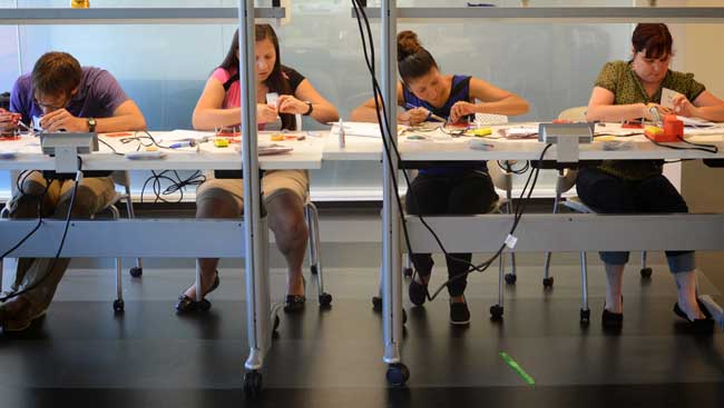 Students participate in hands on activities at a neural engineering workshop. 