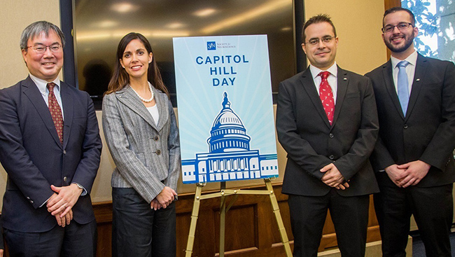 Four people stand around a sign during  SfN's Capitol Hill Day 2017