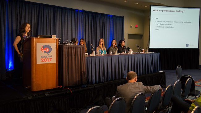 Panelists sit at a long table on a stage during a professional development workshop at Neuroscience 2017.