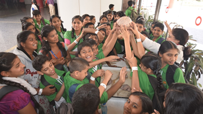 Group of kids holding a brain at Bengaluru's Brain Museum