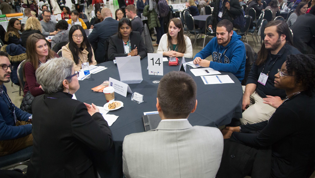 Image of several people engaging in a roundtable discussion at Neuroscience 2017