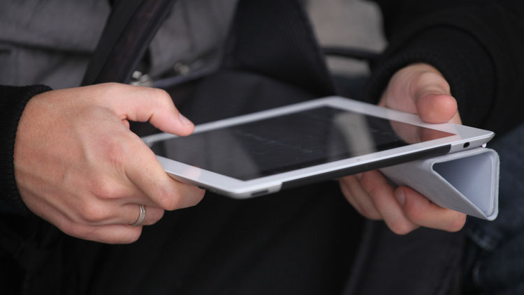 A person holding a tablet.