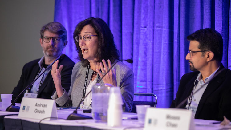 Three neuroscientists sit at a table discussing pharmaceutical partnerships to advocate for basic research