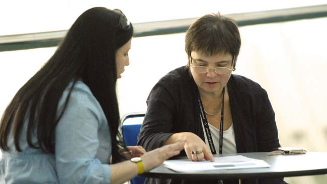 Two females having a discussion.