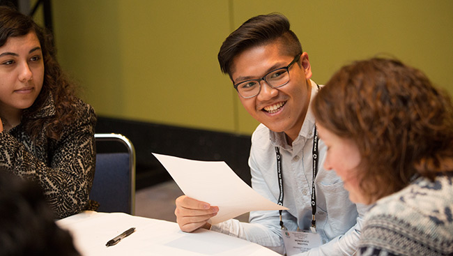 A group of students discuss the best ways to create a curriculum vitae.
