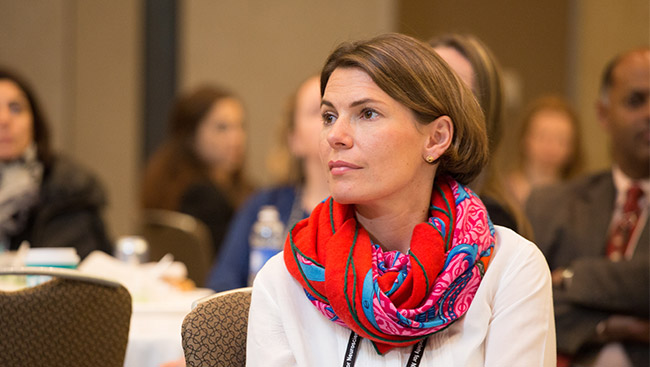 A female neuroscientist listens to a lecture.