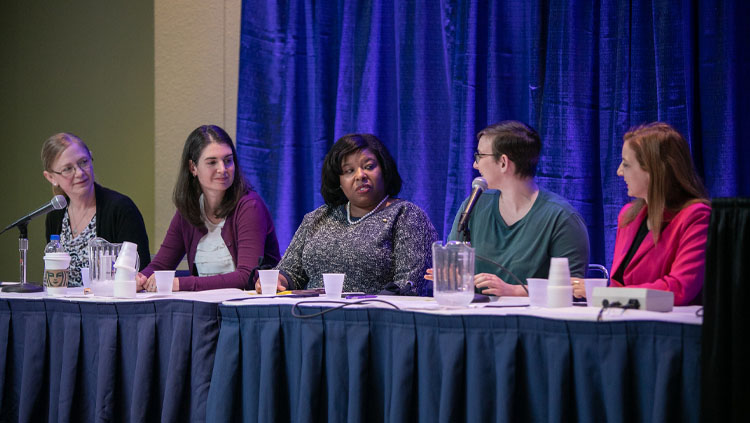 Image of five female panelists sitting at a table at Neuroscience 2019.