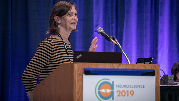 Image of Hollis Cline standing at a podium giving a speech