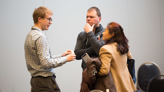 three people having a discussion during the 2017 Neurobiology of Disease Workshop