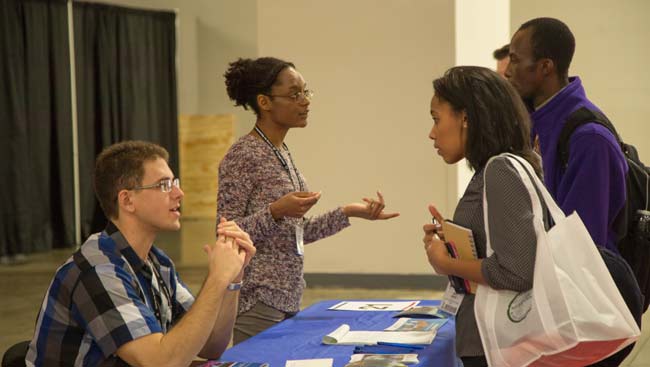 Students seek advice at a graduate school fair.