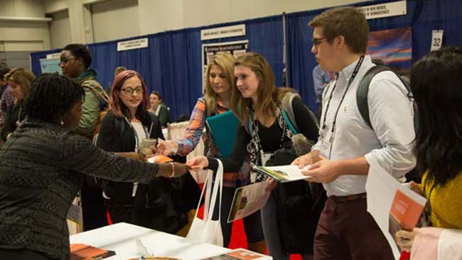 Male and female students get information and discuss lab options. 