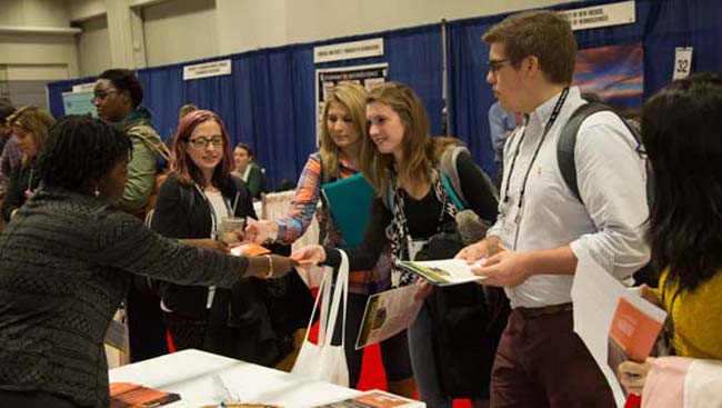 Male and female students get information and discuss lab options.