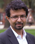Headshot of Anirvan Ghosh wearing a white button down shirt and black jacket