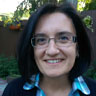 headshot of Silvia Pagliardini wearing glasses and a blue collared shirt.